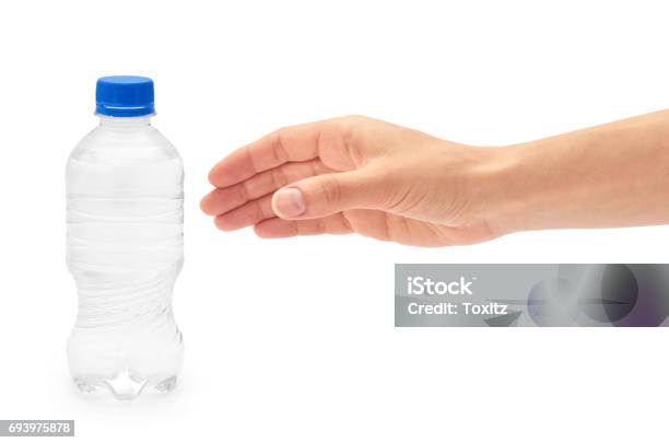 Female Hand Holds Clean And Fresh Water Packed In A Plastic Bottle Isolated On White Background Stock Photo - Download Image Now