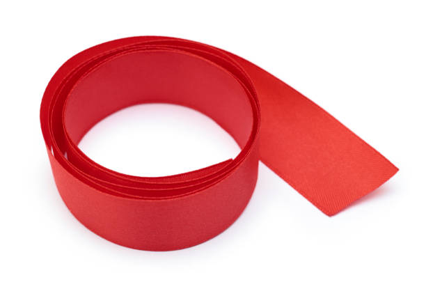 istock Red gift wrapping tape. Isolated on white background 693975908