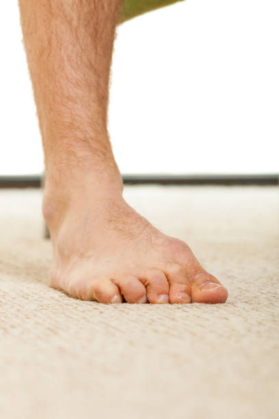 istock Closeup of man foot standing on carpet 693991642