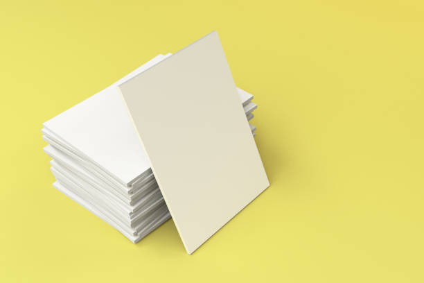istock Stack of blank white closed brochure mock-up on yellow background 693992350