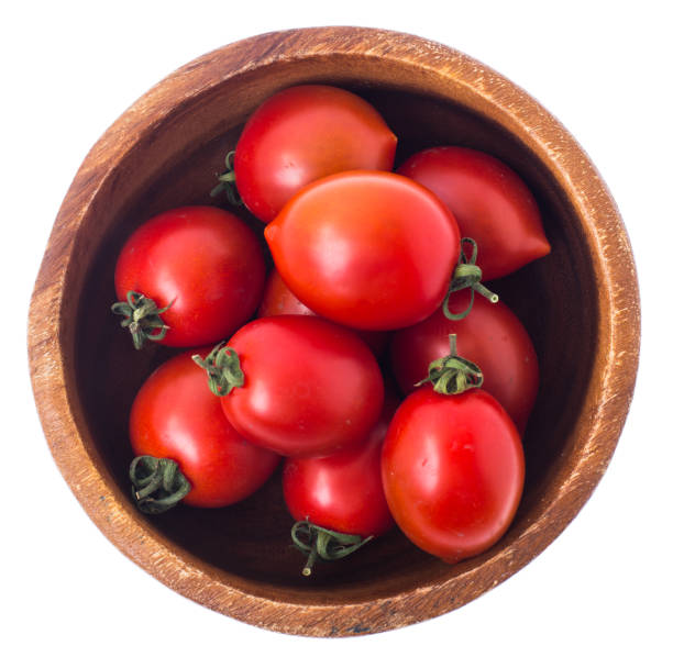 istock Red ripe tomatoes in salad bowl on white background, top view 693996472