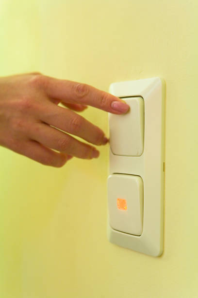 istock A woman's hand with a manicure presses the button of the switch. 693996806