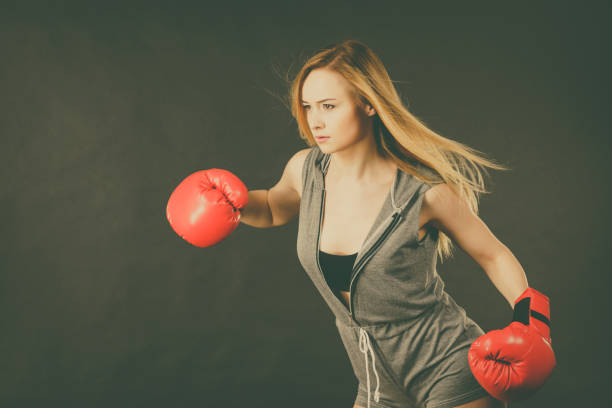 istock Woman wearing boxing gloves 693997390
