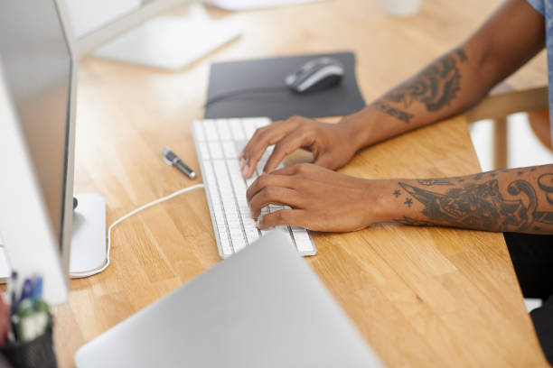 Shot of an unrecognisable designer working on a computer in an office