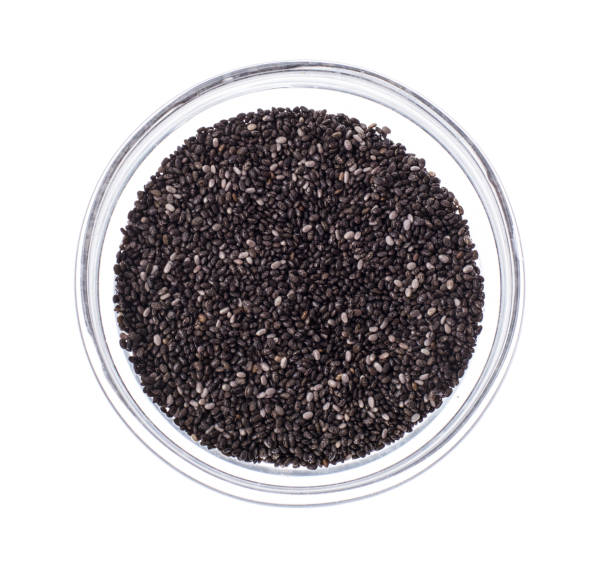 istock Chia seeds in glass on white background 694004178