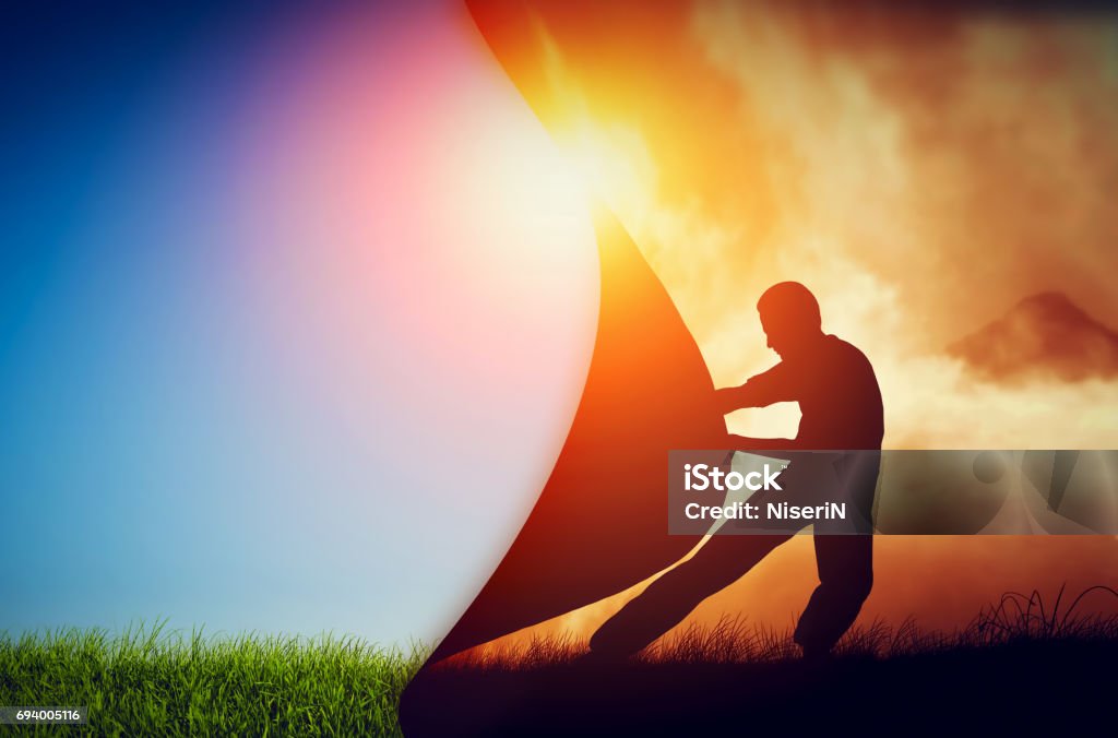 Man pulling curtain of darkness to reveal a new better world. Change. Man pulling curtain of darkness to reveal a new better world. Conceptual change, two worlds, hell and paradise. Change Stock Photo