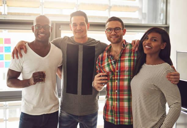 istock Cheerful office team standing with the beverages 694007526
