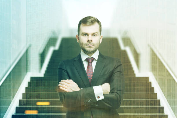 istock Confident businessman on staircase front toned 694016312