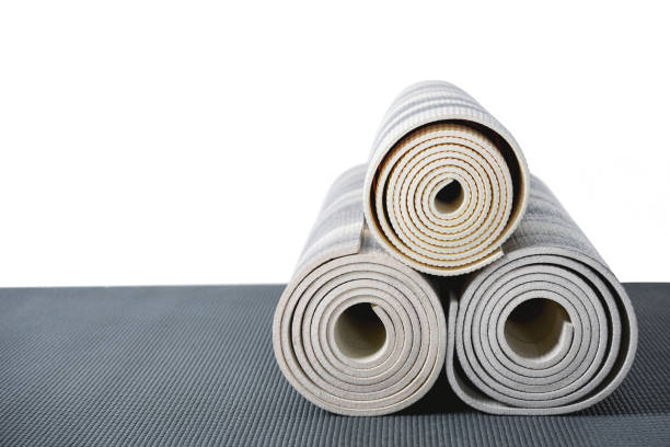 istock yoga mats lying on grey mat isolated on white with copy space 694018818