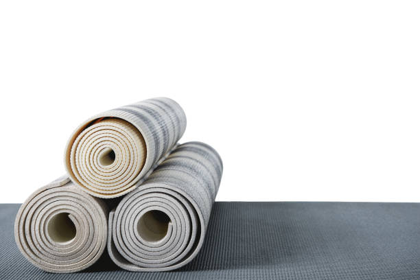istock yoga mats lying on grey mat isolated on white with copy space 694018886