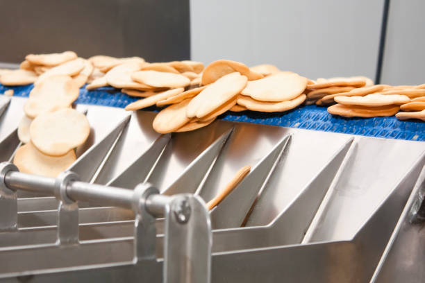 istock Crackers moving in a production and packing line. 694029226