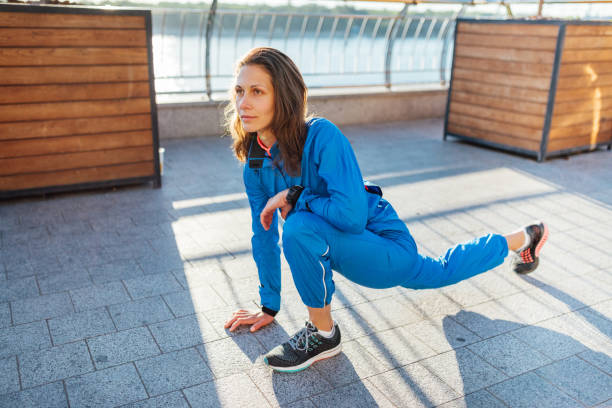 istock Young woman stretching before jogging exercise 694032646