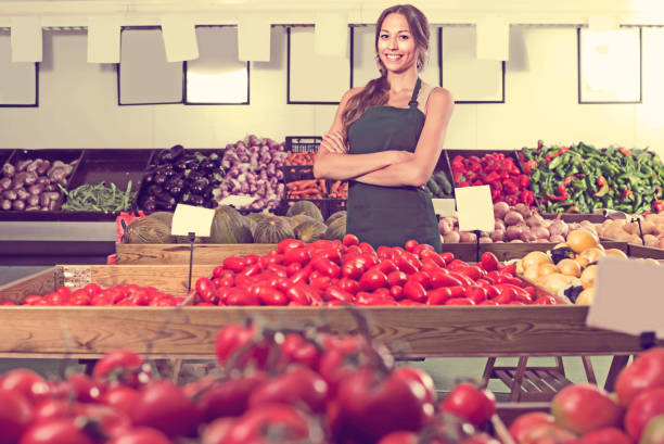 istock Glad female seller wearing apron 694034114