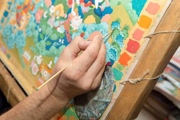 istock The artist paints a Buddhist icon 694039858