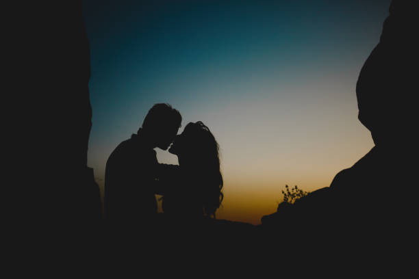 istock Almost kissing couple in twilight 694040936