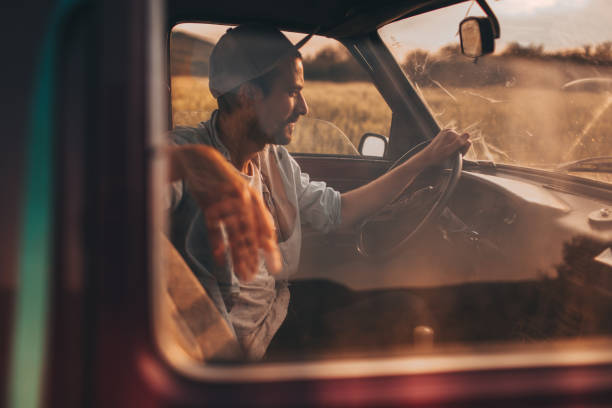 istock Young man riding an old pick up truck 694040984
