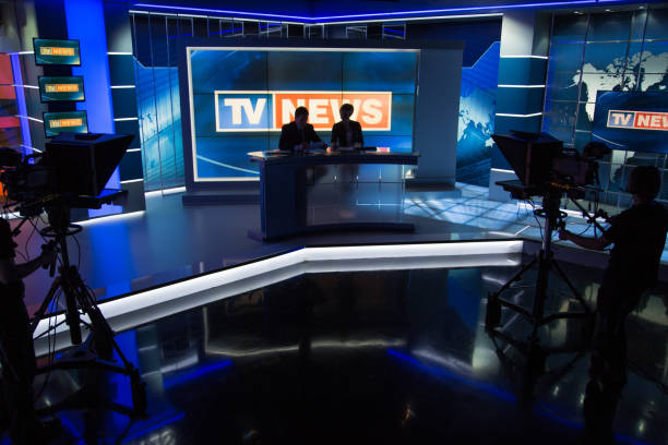 istock Newsreader filming in press room 694041072