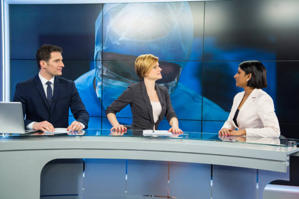 istock Journalists sitting with businesswoman 694041086