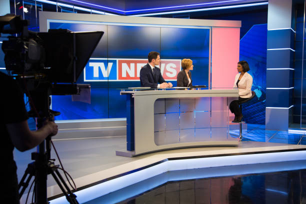 Newsreader filming in press room Journalist taking live interview of businesswoman in television studio. media interview photos stock pictures, royalty-free photos & images