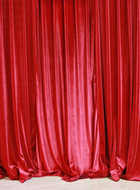 istock Red closed curtain background in a theater. 694044748