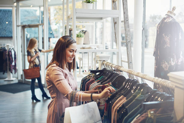 I know I'll find something I like here Shot of a young woman shopping at a clothing store shop stock pictures, royalty-free photos & images