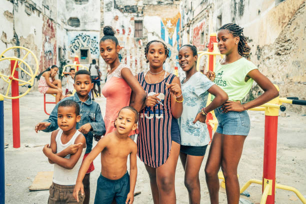 Havana, Cuba - February 21, 2017: Group of cuban kids posing for a picture at new playground in the courtyard between the old colonial houses.