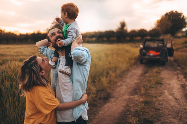 Family time! Photo of young family spending some quality time together outdoors in nature, with their baby boy 4x4 photos stock pictures, royalty-free photos & images