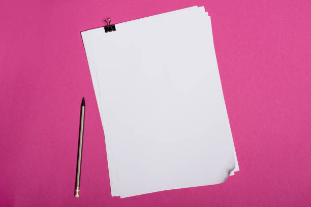 istock Top view of blank white papers and pencil isolated on pink 694048014
