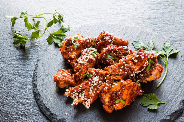 istock Glazed pork, black stone background, fresh parsley. 694054372