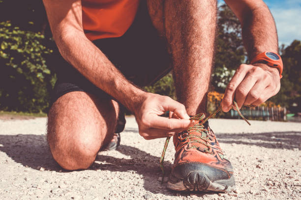istock Close-up of man runner lacing his shoes 694054530
