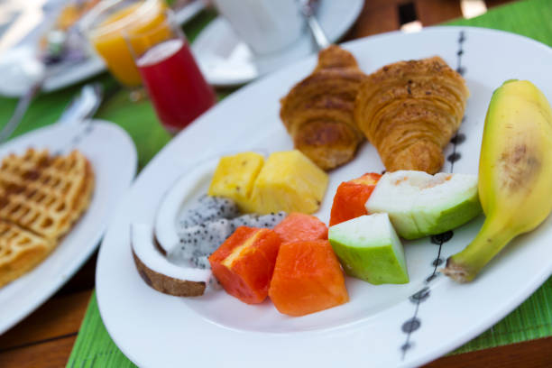 istock Breakfast with Tropical Fresh Fruit and Pancakes 694057622