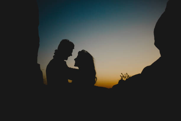 istock Embracing couple in twilight 694058368