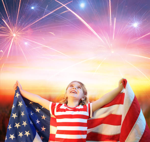 little girl with usa flag celebrating under fireworks - child flag fourth of july little girls imagens e fotografias de stock