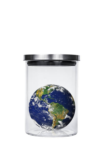 istock earth in a jar on white background, concept global warming. Earth image provided by Nasa. 694065944