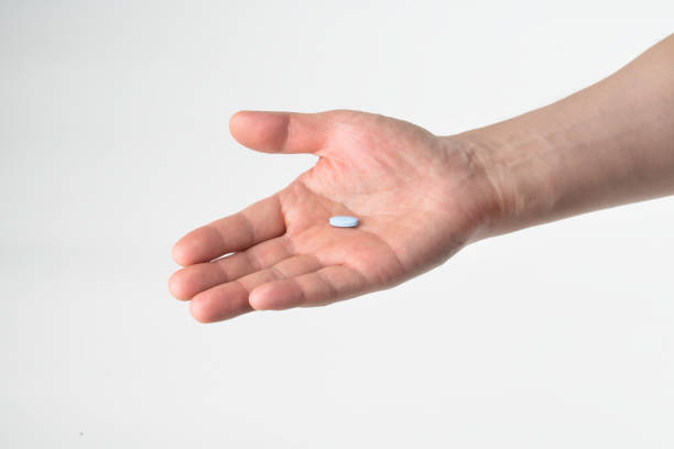 istock Pills in palm of hand. 694072434