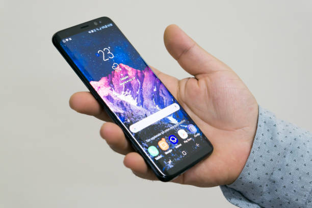 Holding Samsung Galaxy S8 stock photo