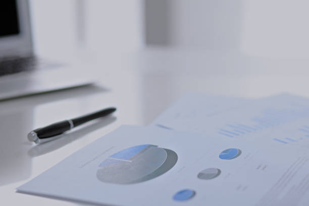 istock Office workplace with a laptop and financial documents 694075732