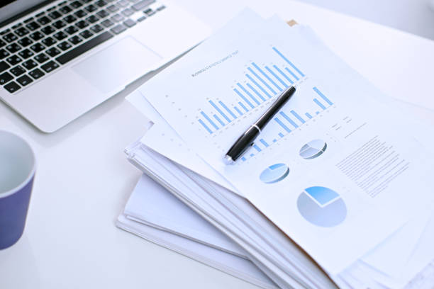 istock Office workplace with a laptop and financial documents 694075934