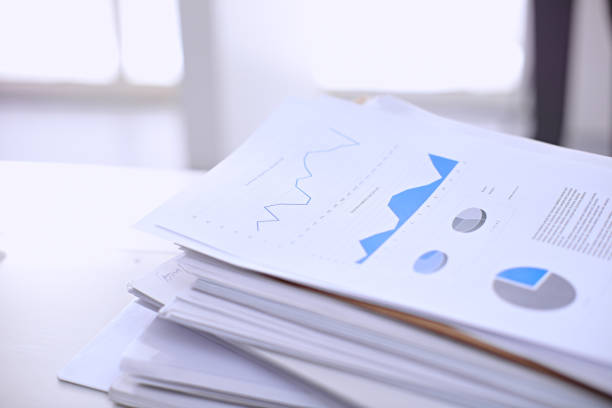 istock Office workplace with a laptop and financial documents 694076186