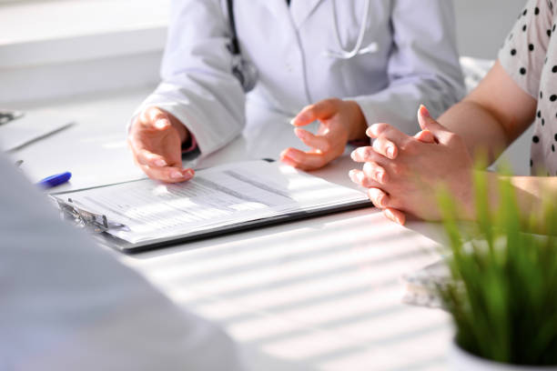 istock Doctor and patient are discussing something, just hands at the table 694076738