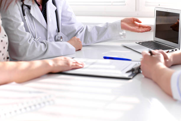 istock Doctor and patient are discussing something, just hands at the table 694076946