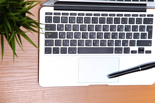 istock Office table with laptop, notepad and coffee cup. View from above with copy space 694079520