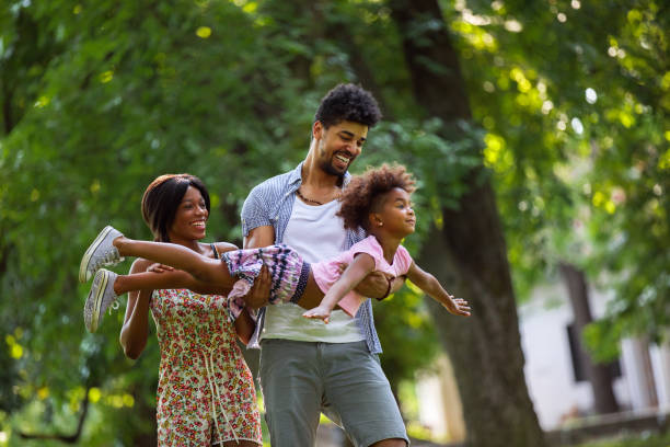 istock Father carrying his daughter and helping her fly 694079604