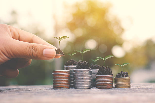 istock Close-Up Of Hand Placing Coin On Stack 694087911