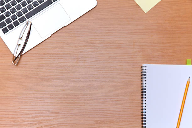 istock Office table with laptop, notepad and coffee cup. View from above with copy space 694090380