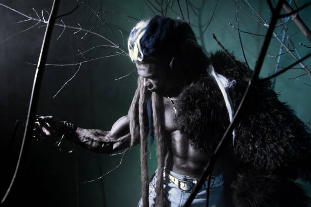 istock Muscular werewolf among the branches of the tree 694090938