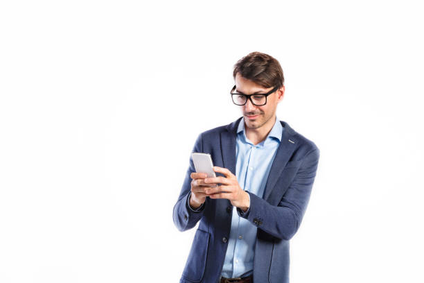 istock Handsome young man with smart phone. Studio shot, isolated. 694091406