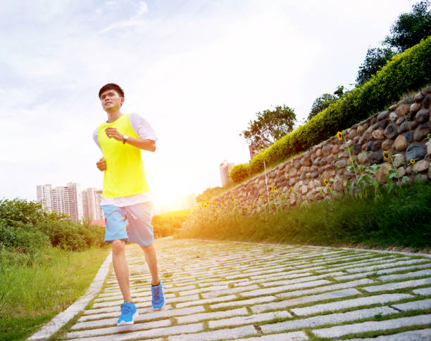 istock Young man jogging in the park 694092106
