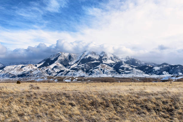 Dramatic Clouds Over Montana Mountains in Winter Snow covered mountains in Paradise Valley region of Montana. moody sky stock pictures, royalty-free photos & images