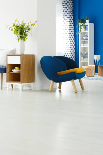istock Blue chair in white room 694095026